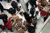 Shoppers look at handbags on display at the Macy's Inc. flagship store in New York, U.S., on Thursday, Nov. 28, 2019. A gauge of buying conditions in the U.S. advanced last week to 55.3, the highest ever leading up to the first shopping day after the Thanksgiving holiday, according to Bloomberg Consumer Comfort Index data.