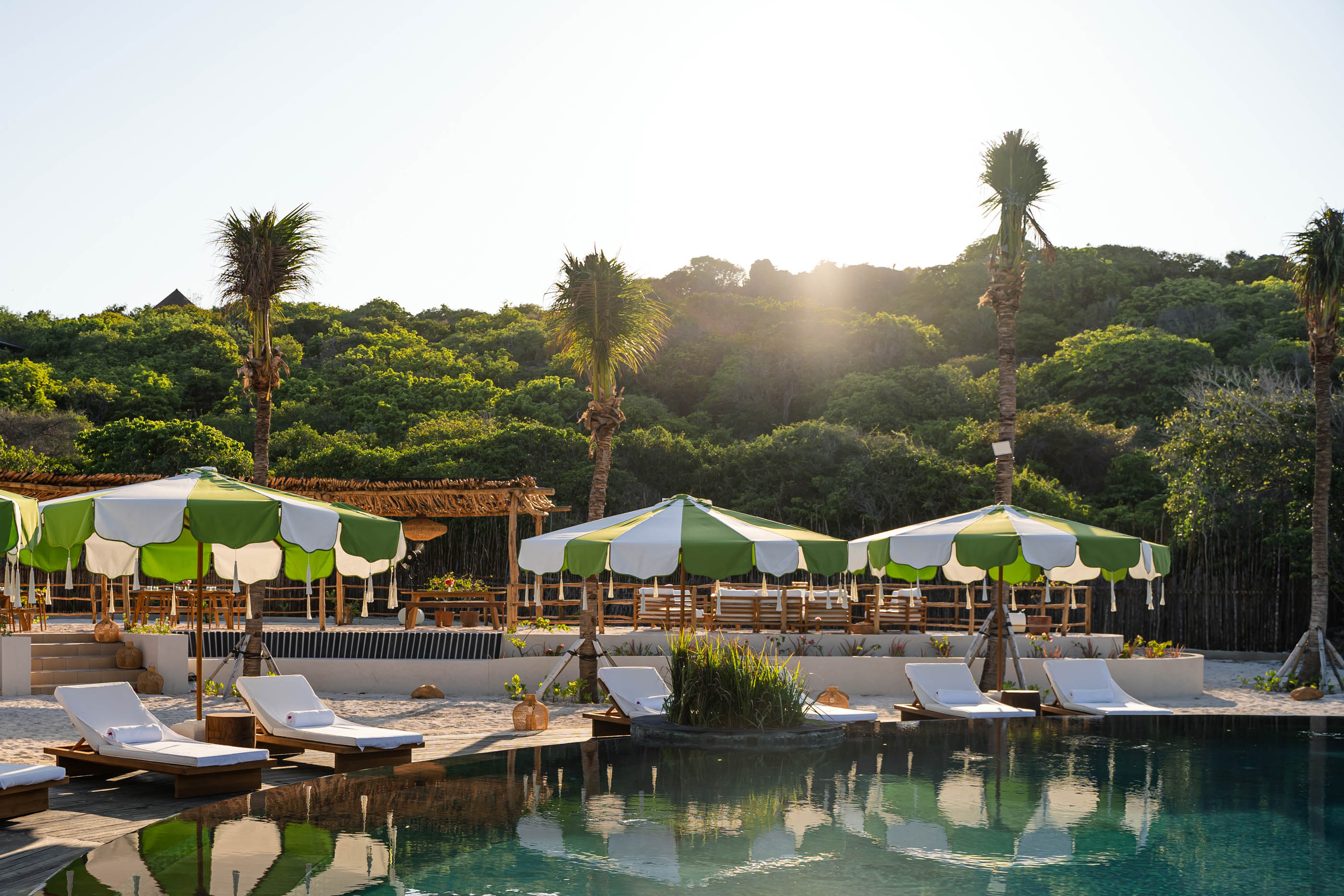 A swimming pool with chairs at the Nihi Rote.