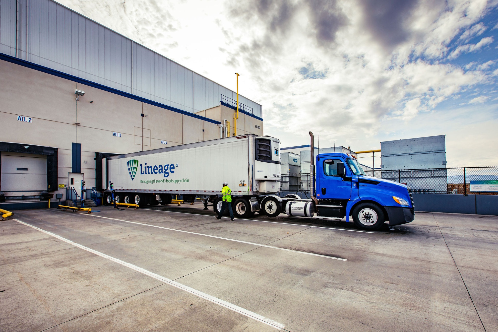 A refrigerated truck arrives at a Lineage Logistics warehouse facility.