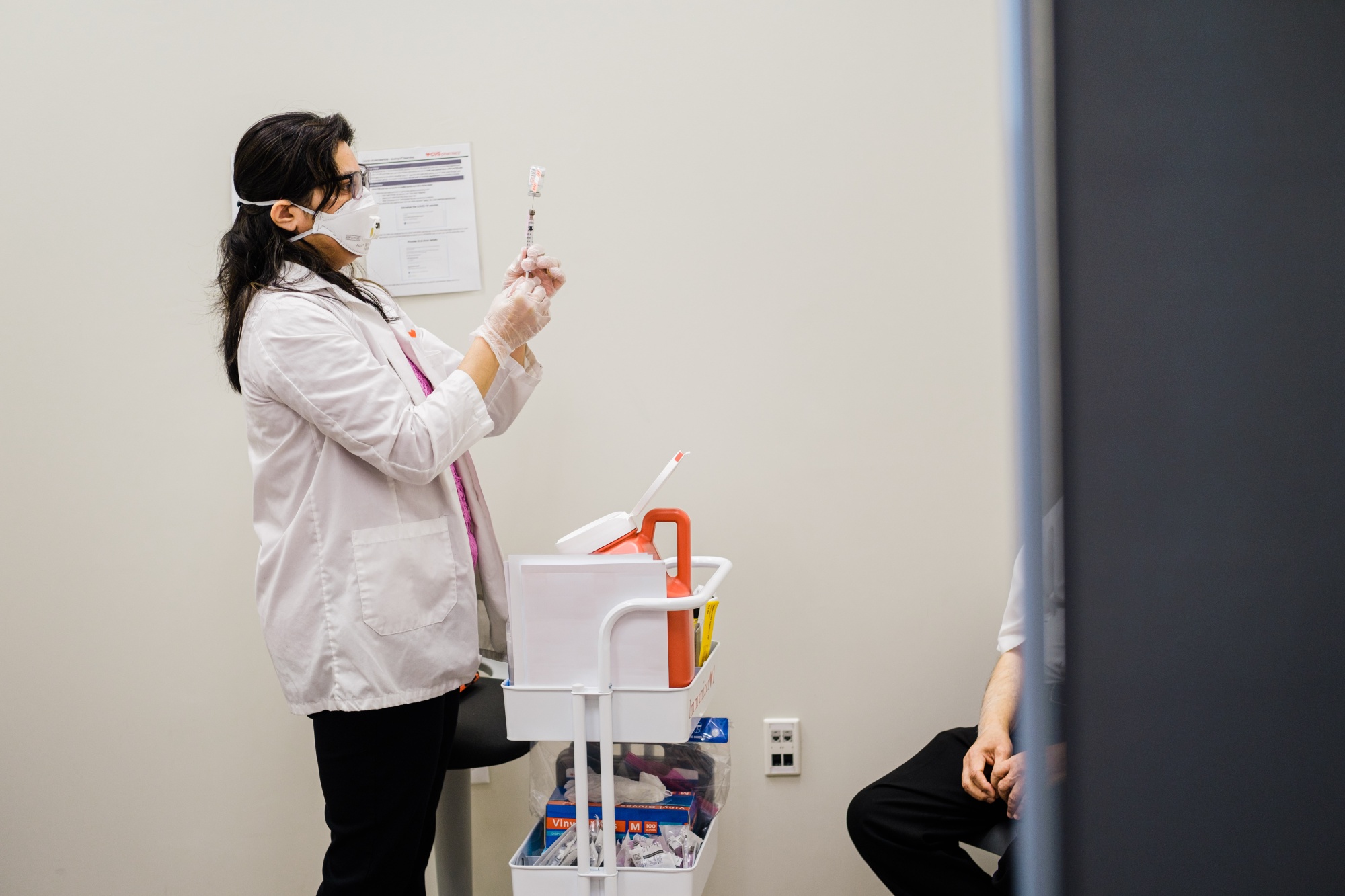 A pharmacists prepares a Covid-19 vaccination at a CVS Pharmacy in Eastchester, New York.