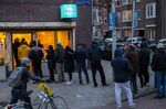 Customers queue to buy marijuana at the Bulwackie coffeeshop in Amsterdam, on March 15.