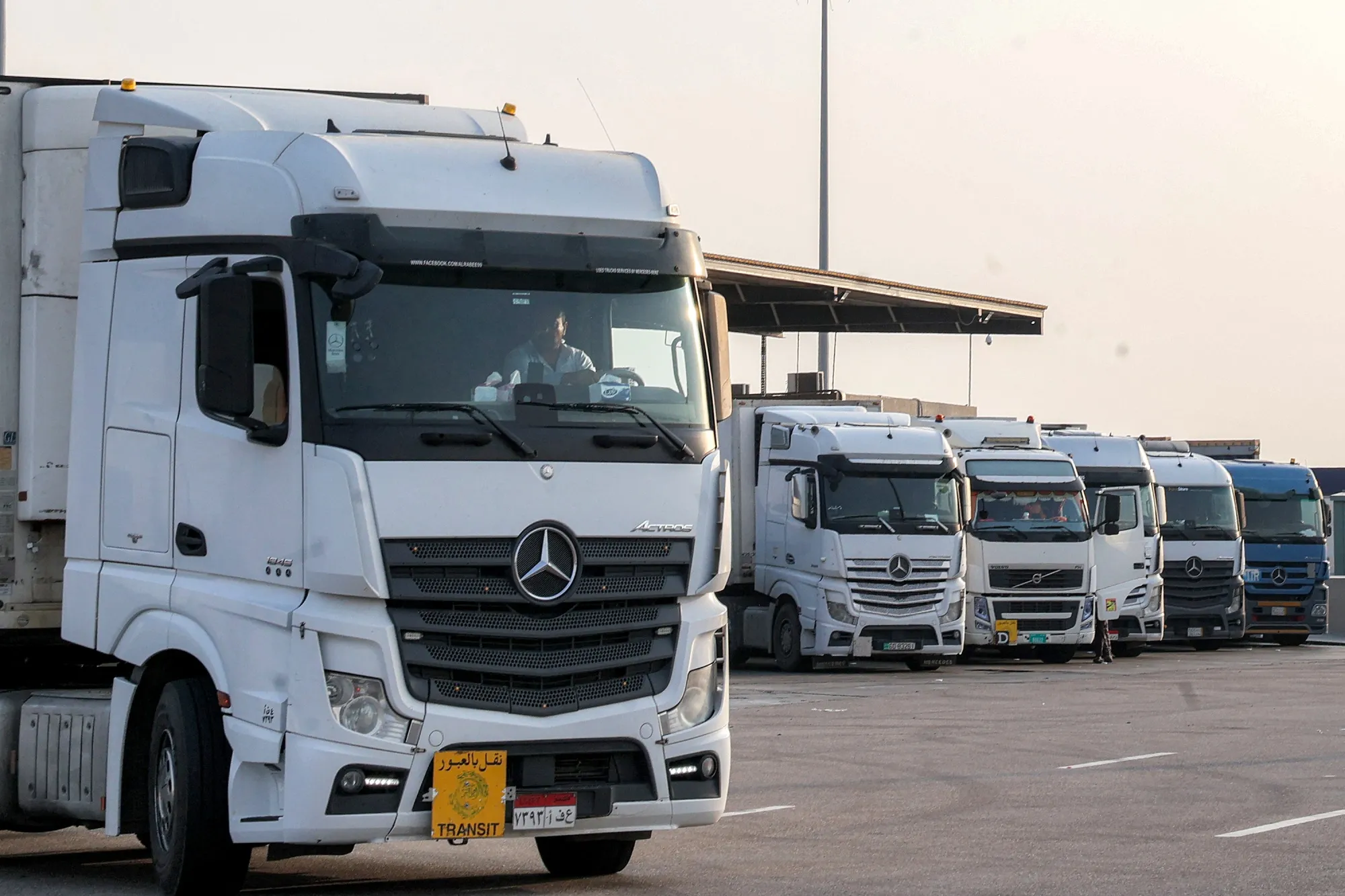 Trucks carrying goods wait to cross into Qatar from the Salwa border-crossing in eastern Saudi Arabia on March 15.