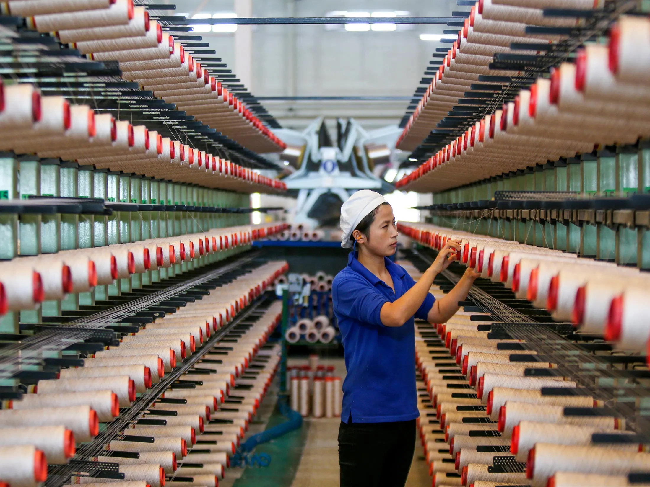 Yarn production at a textile factory in east China’s Jiangsu province.