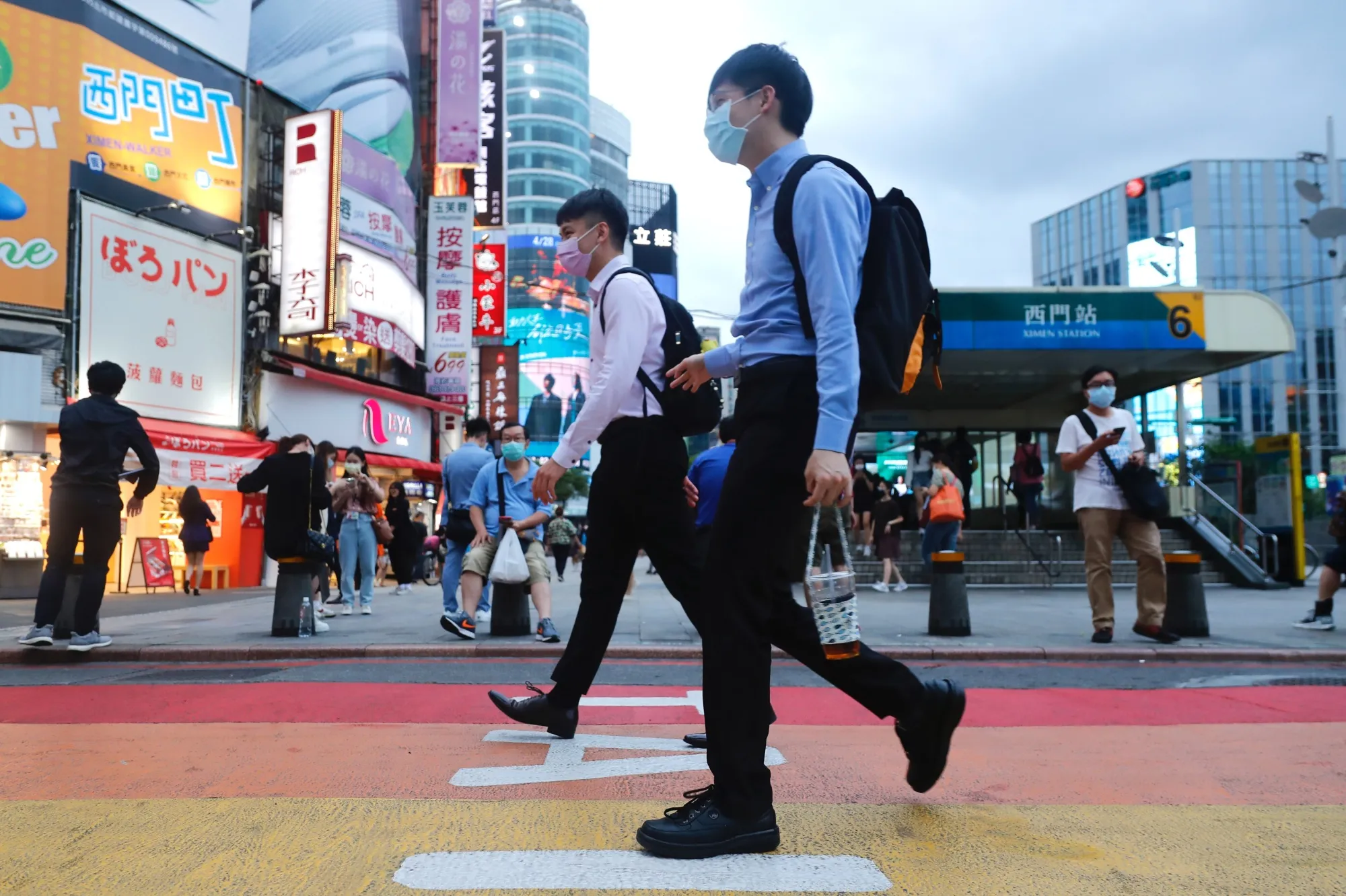 Pedestrians walk along a road in Taipei on May 12.