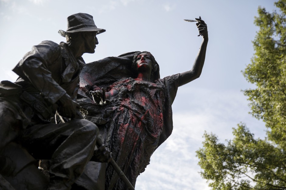 A statue depicting a Confederate soldier in Piedmont Park in Atlanta is vandalized with spray paint Monday, Aug. 14, 2017.