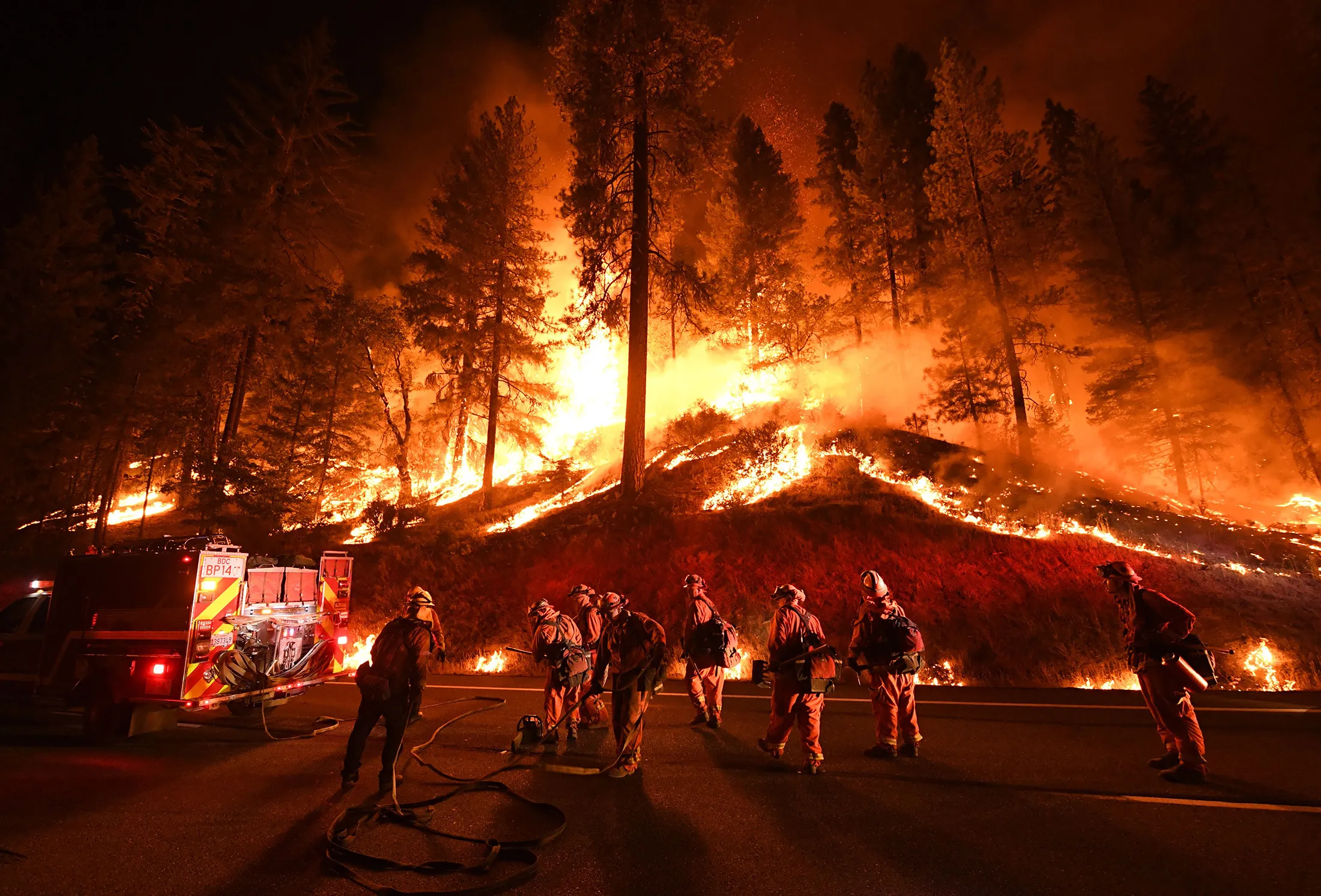 Firefighters try to control a back burn as the Carr fire continues to spread near Redding, California, on July 31, 2018.&nbsp;