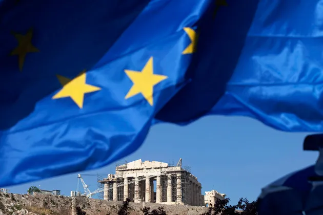 The European Union flag flies near the Parthenon on the Acropolis of Athens
