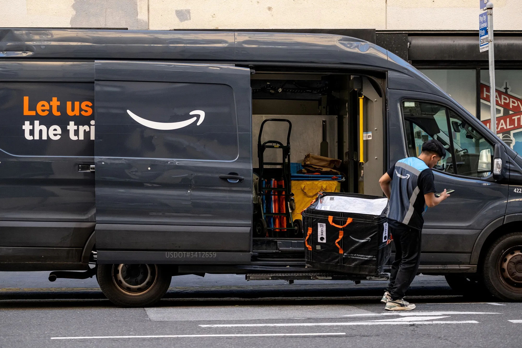 Um funcionário próximo a encomendas em um veículo de entrega da Amazon em São Francisco, Califórnia, EUA.