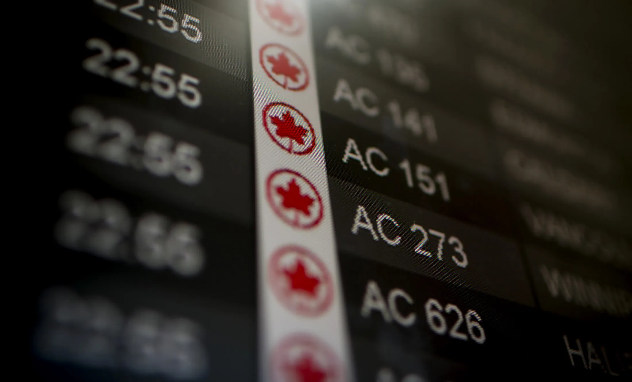 Air Canada flights are listed on a board at Toronto Pearson International Airport in Toronto, Ontario, Canada, on Wednesday, July 3, 2013.
