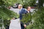 White House Chief of Staff John Kelly (C) shakes hands with an unidentified man as Assistant Attorney General Rod Rosenstein (R) walks away after a meeting at the White House in Washington, DC, on September 24, 2018.