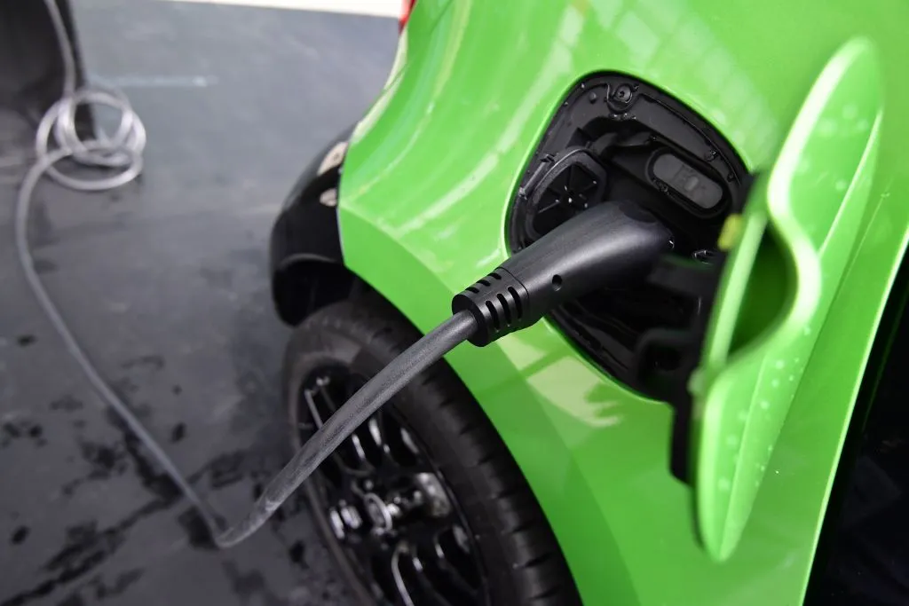 An electric car is recharged at a loading station in Frankfurt am Main, central Germany, on September 13, 2017.
