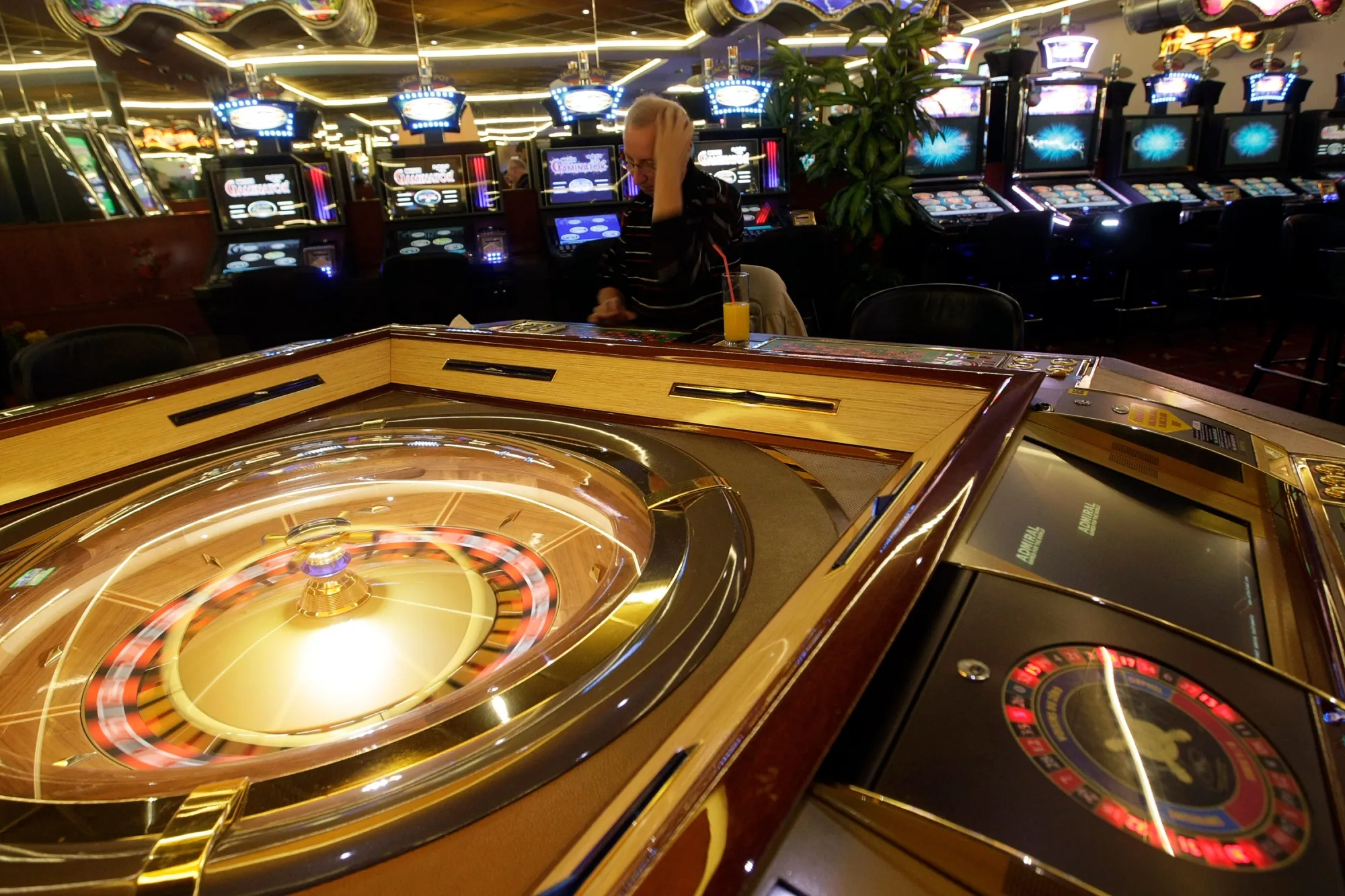 A customer plays roulette in a casino in Budapest.