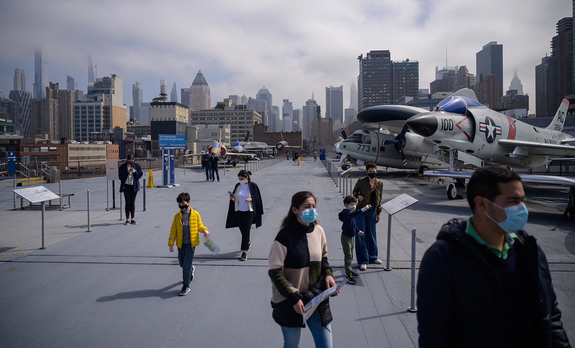 Visitors walk past exhibits at the USS Intrepid Sea Air and Space museum after it re-opened following closure due to the pandemic, in New York on March 25.
