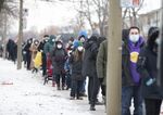 Residents wait in line outside a Covid-19 testing center in Montreal, Quebec on Dec. 22.