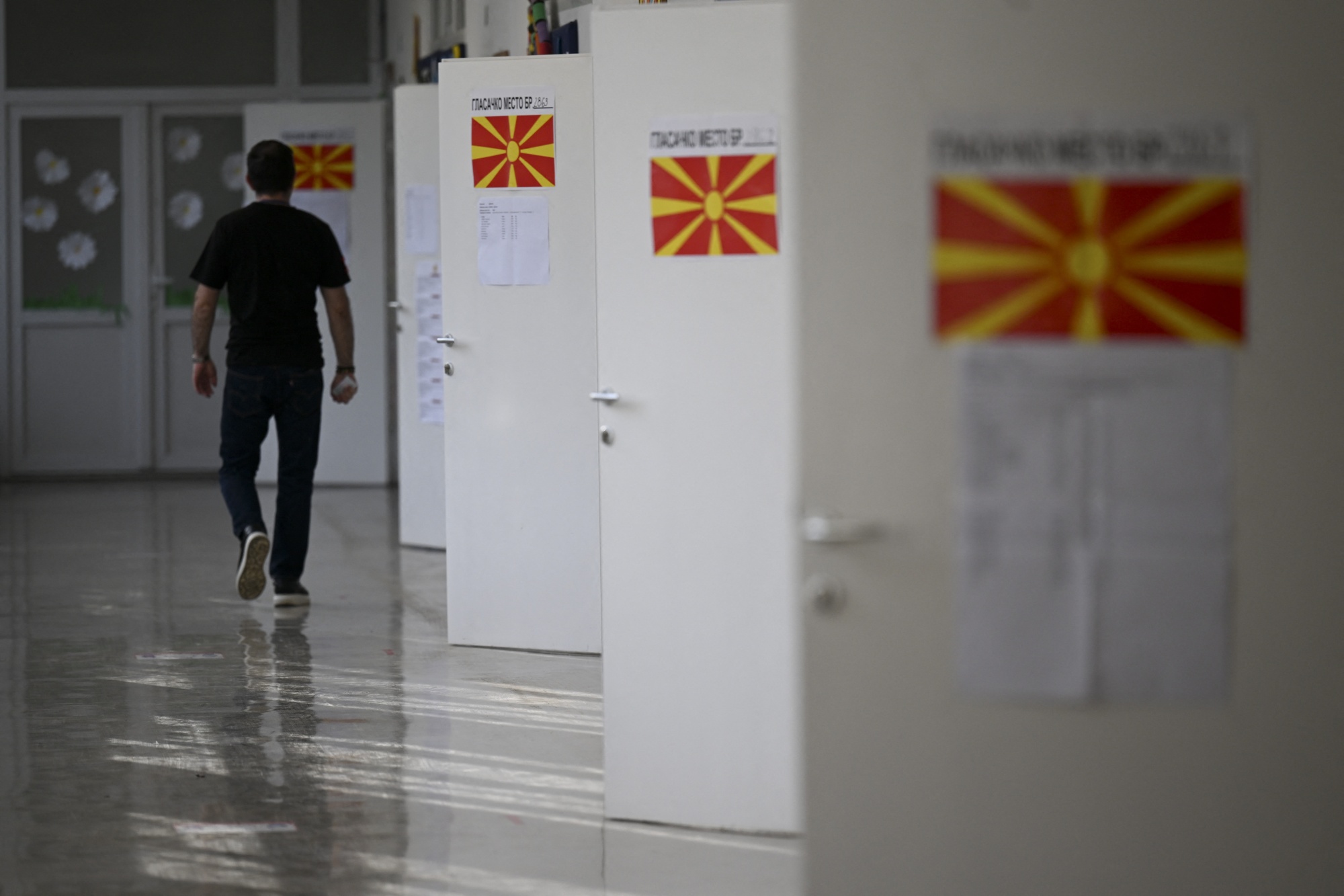 A voter arrives to cast their ballot at a polling station in Skopje on May 8, 2024.