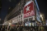 Pedestrians pass by a Macy’s department store in New York.