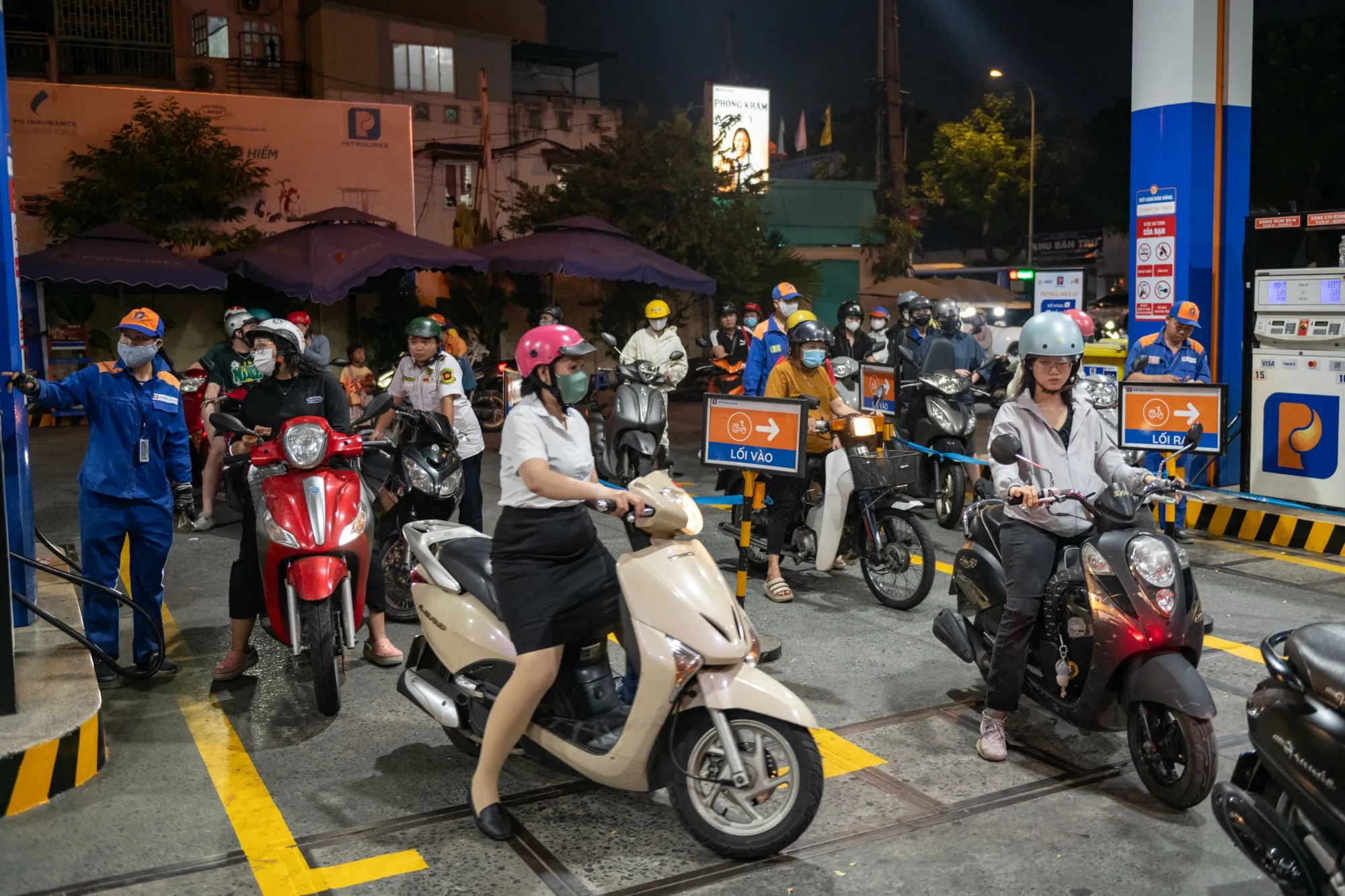Motorists queue to fill up fuel at a gas station in Ho Chi Minh City.