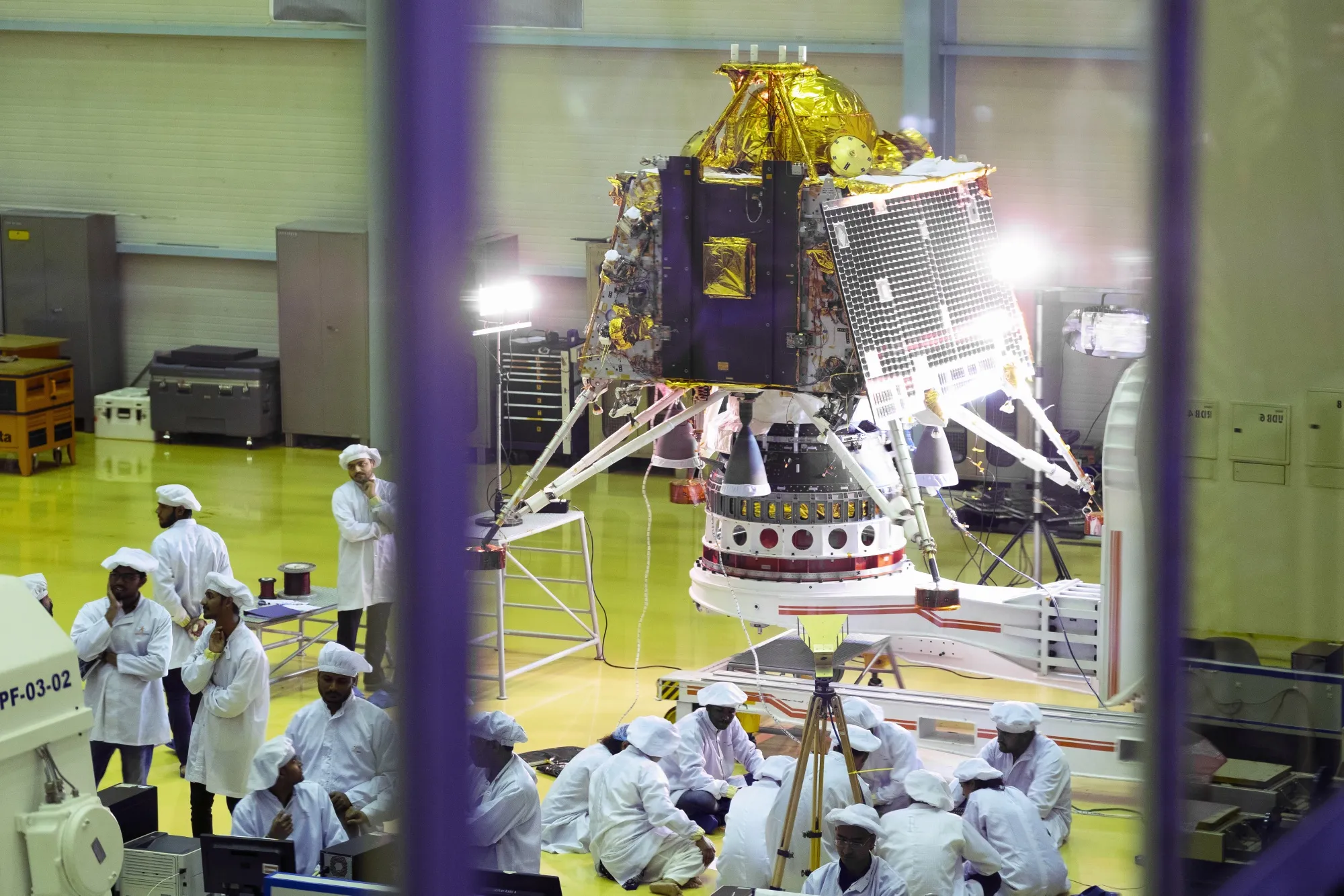 Scientists and employees view the Chandrayaan-2 spacecraft Lander module at the Indian Space Research Organization Satellite Integration and Test Establishment (ISITE) at the ISRO headquarters in Bengaluru, India, on June 12, 2019.