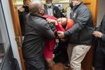 A member of Parliament from the Economic Freedom Fighters is dragged out of a Parliamentary sitting by Protection Services, in Cape Town, on June 9.&nbsp;