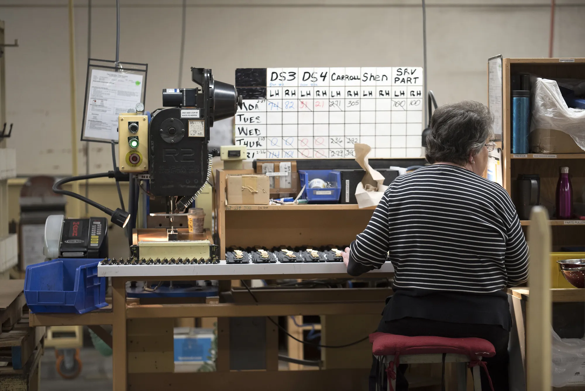 A worker assembles window latches at a manufacturing facility in Pella, Iowa.