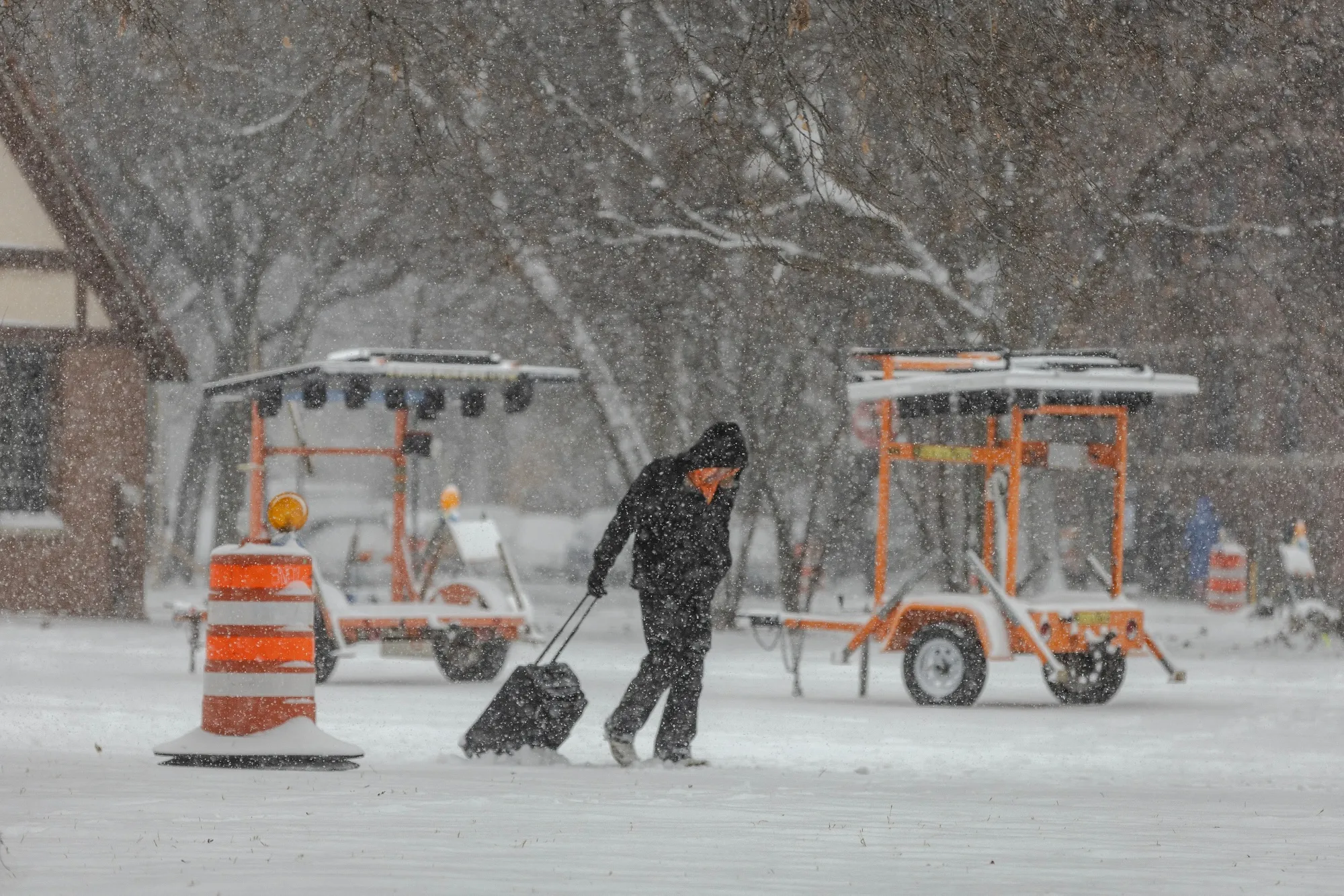 A pedestrians pulls a roller bag through the snow during a snowstorm in Chicago on Nov. 29.