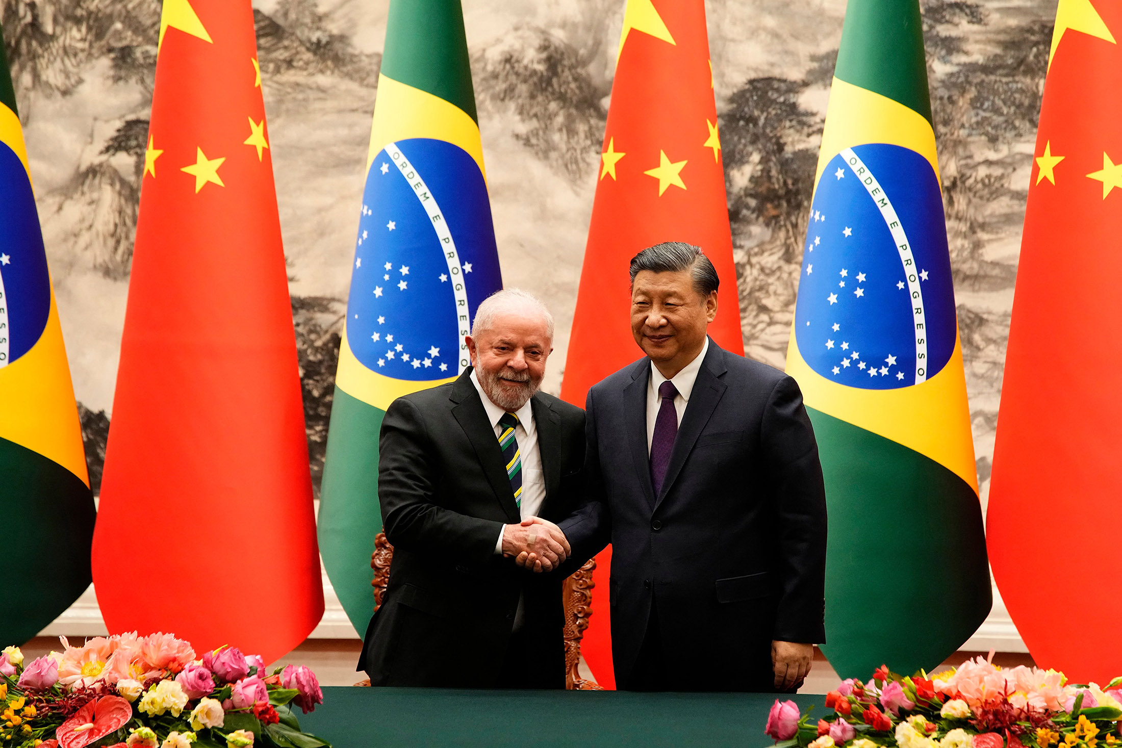 Xi Jinping and Luiz Inacio Lula da Silva shake hands after a signing ceremony at the Great Hall of the People in Beijing on April 14.