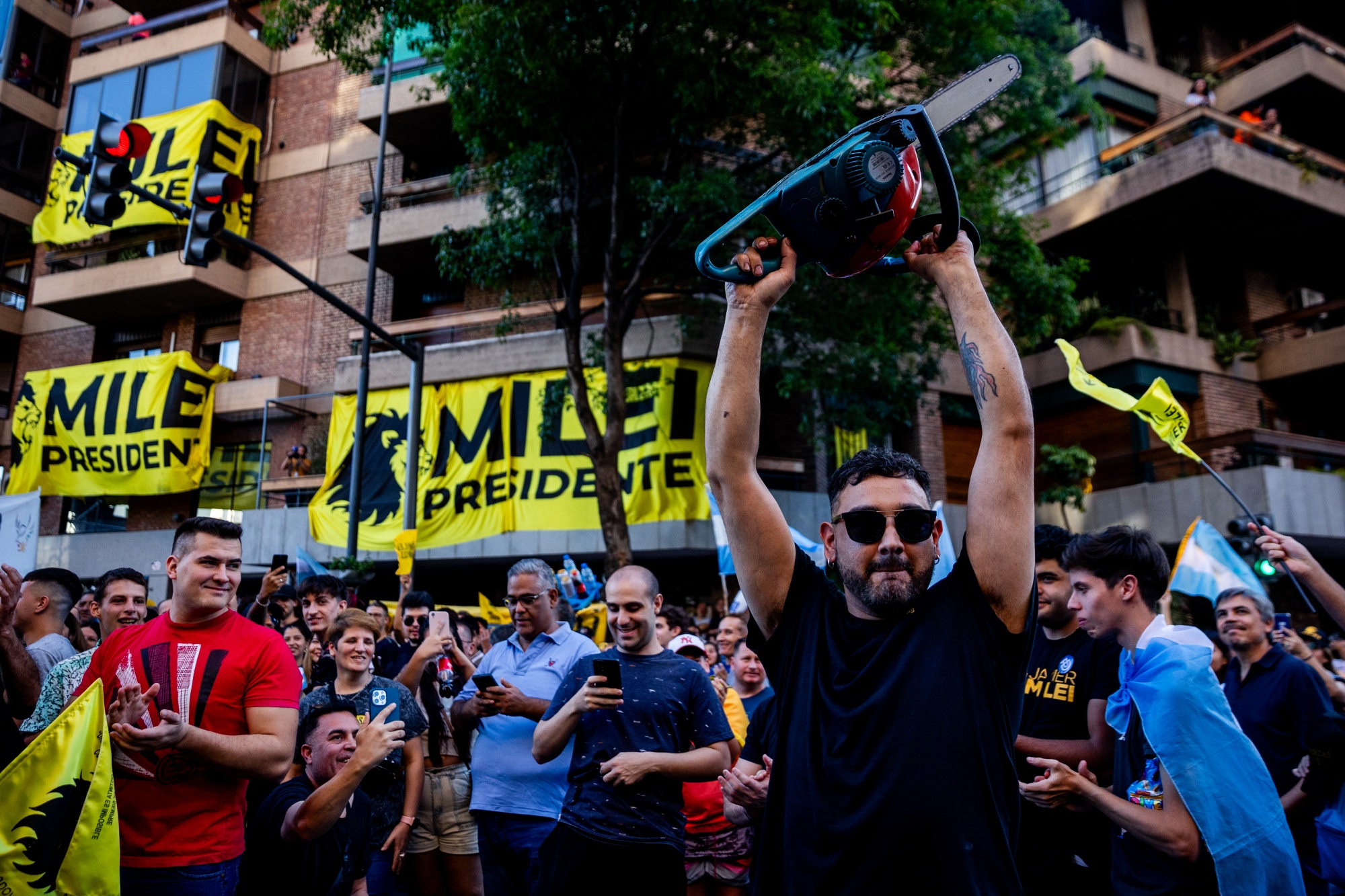 A Javier Milei's supporter wields a chainsaw during a rally in Cordoba, in 2023. Photographer: Tomas Cuesta/Getty Images