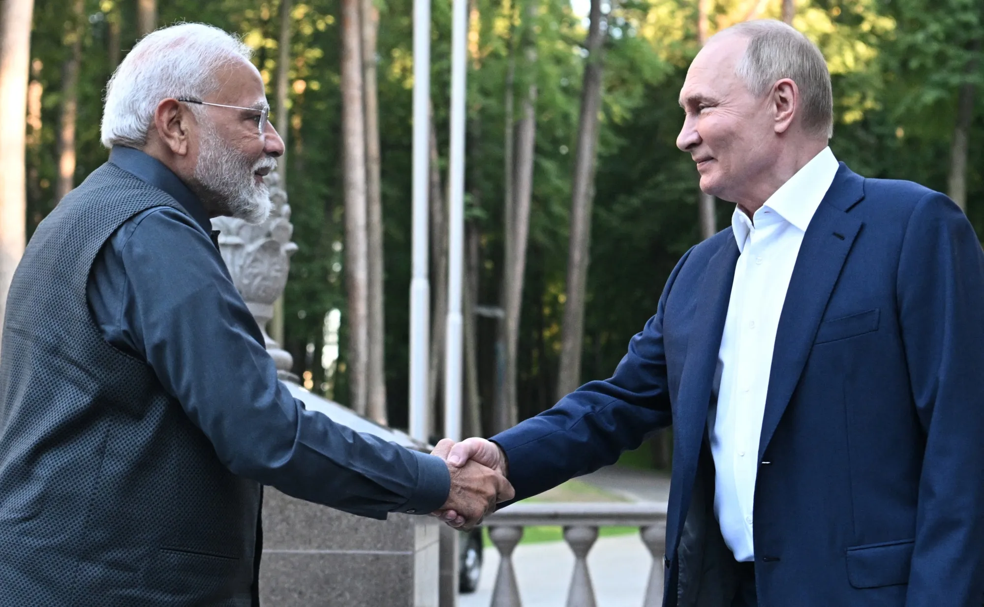 In this pool photograph distributed by the Russian state agency Sputnik, Narendra Modi&nbsp;and Vladimir Putin shake hands during an informal meeting at the Novo-Ogaryovo state residence, on July 8.