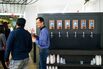 People talk by the beer kegs on the amenities floor at Equity Office’s 100 Summer Street building in Boston&nbsp;on&nbsp;Jan. 3, 2018.