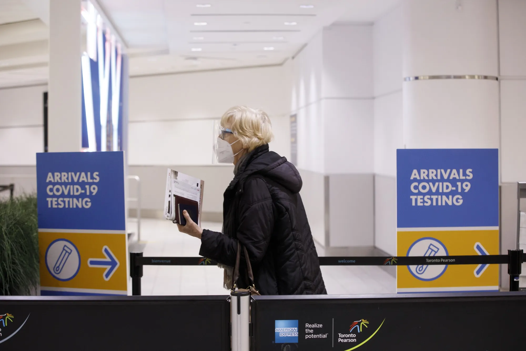 An arriving traveler walks toward a mandatory Covid-19 testing area at Toronto’s Pearson airport in February.