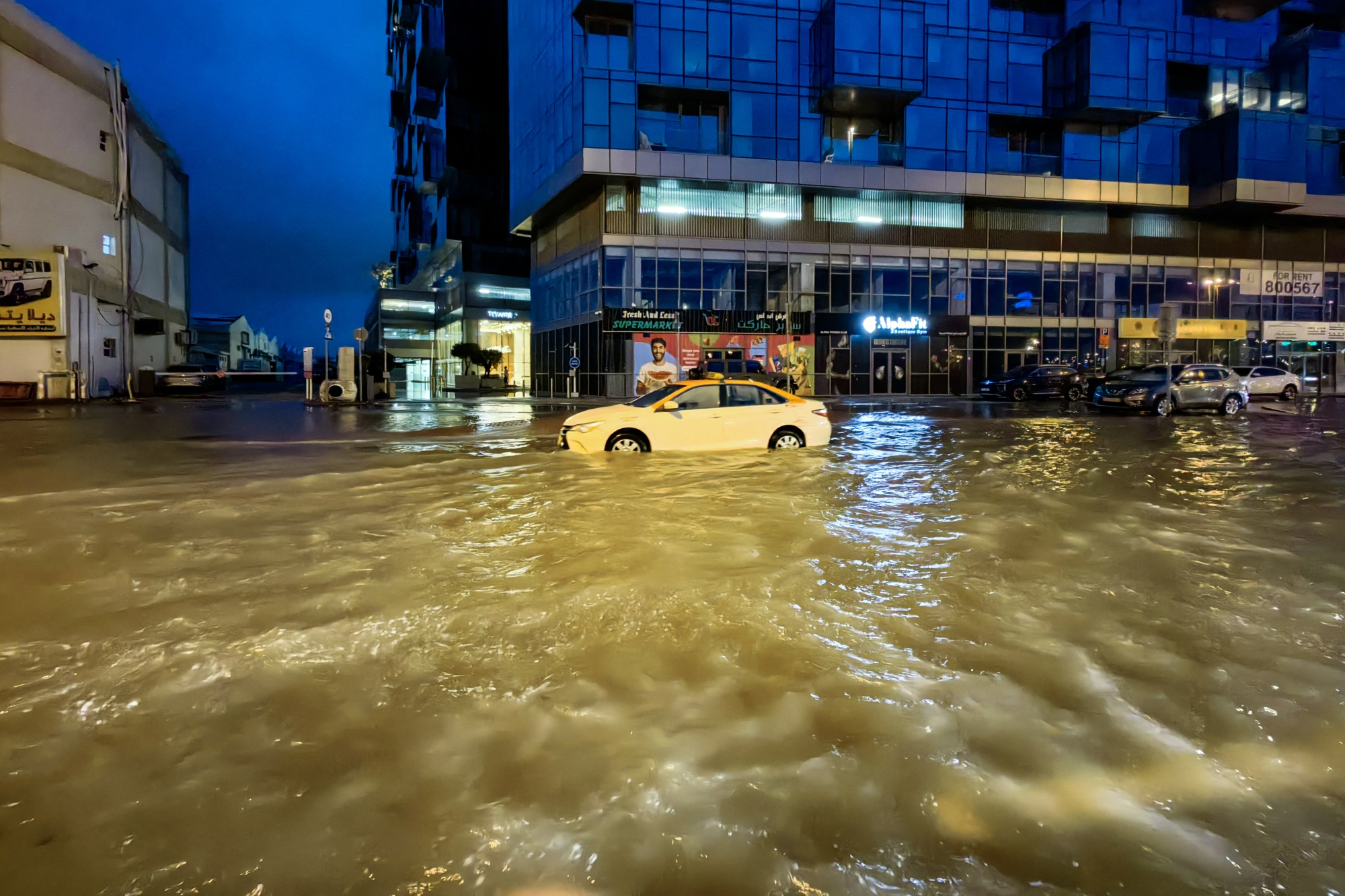 A taxi navigates floodwaters in Dubai.
