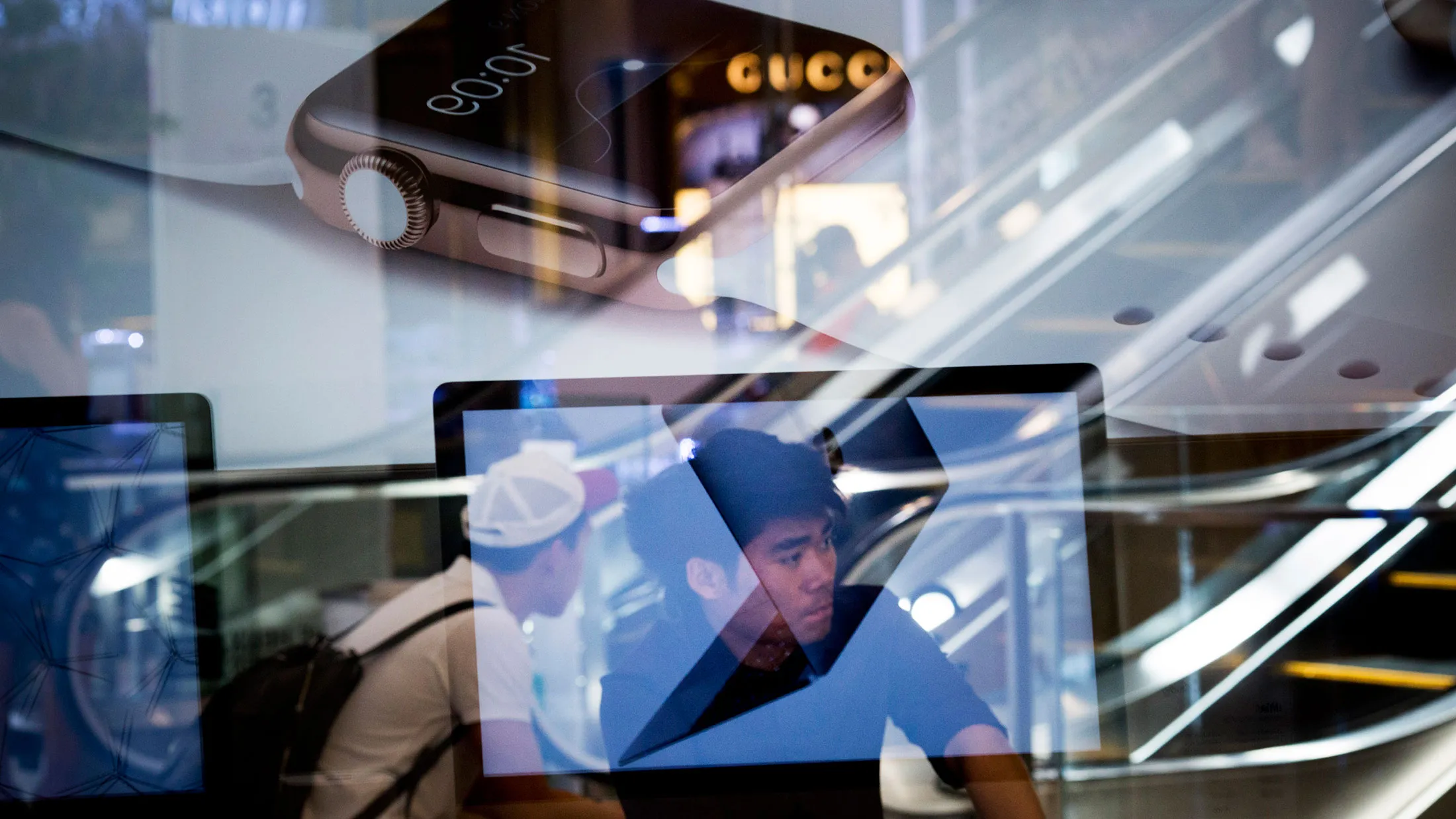 Customers wait to enter to purchase Apple Inc. Apple Watches in Bangkok.
