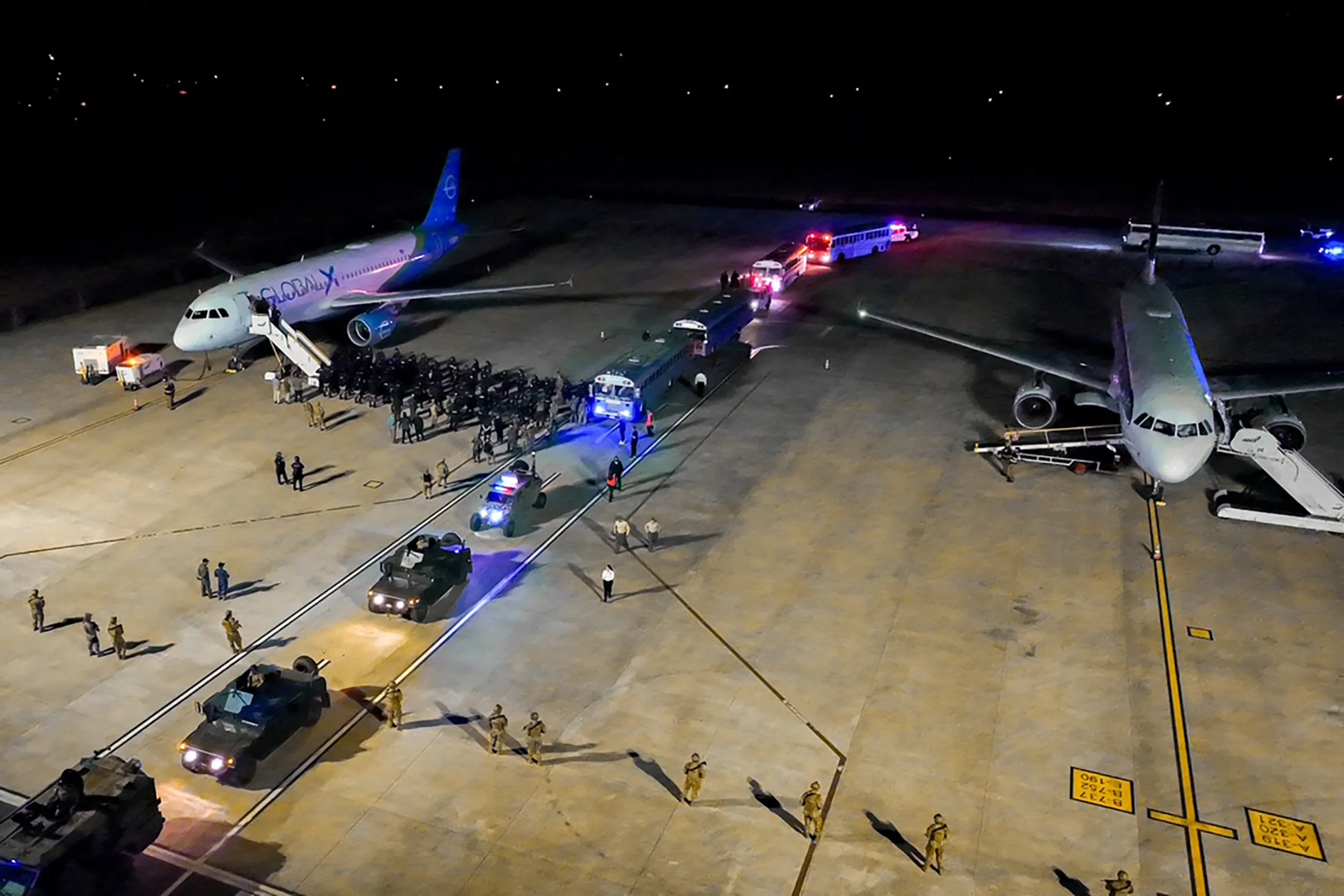 Buses arrive to transfer deported individuals from the US to the Terrorism Containment Center (CECOT) maximum security prison, in this photo released by the El Salvador Presidency.