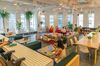 Members work in the cafeteria at the WeWork Cos Inc. 85 Broad Street offices in the Manhattan borough of New York, U.S., on Wednesday, May 22, 2019. WeWork has become the biggest private office tenant in London, Manhattan and Washington on its way to 425 office locations in 36 countries overall.