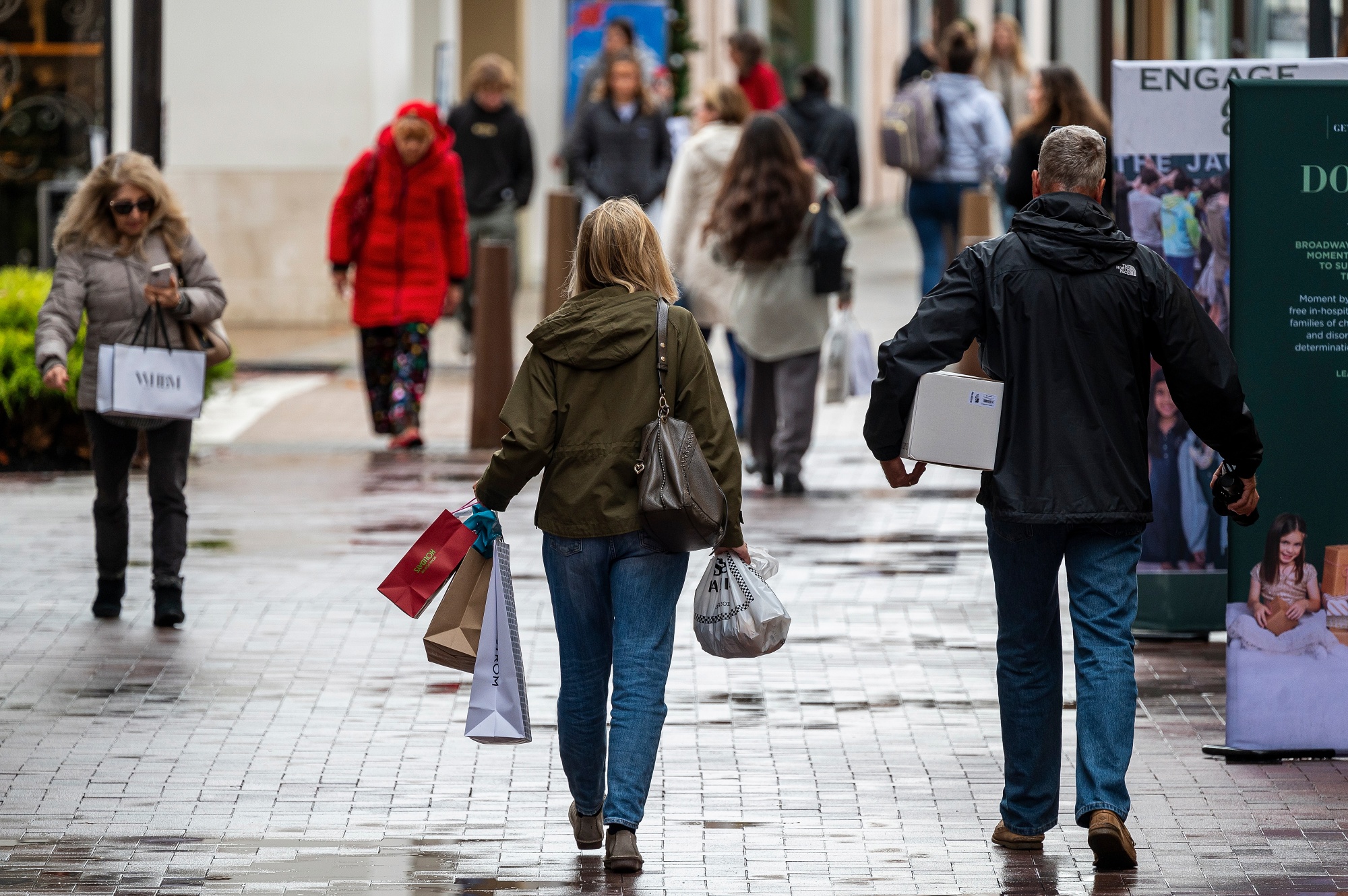 Shoppers carry bags in Walnut Creek, California in December.