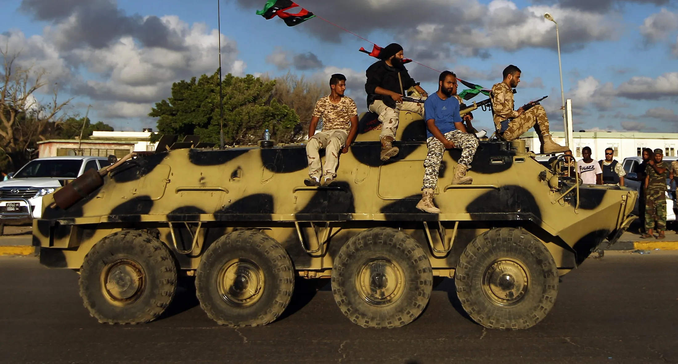 Libyan troops loyal to Khalifa Haftar ride on an APC during a demonstration on Aug. 14, 2015 in Benghazi.
