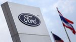 The Ford Motor Co. logo stands on display next to U.S. and Thai flags at the company's factory in Pluak Daeng district, Rayong province, Thailand, on Jan. 28, 2014.
