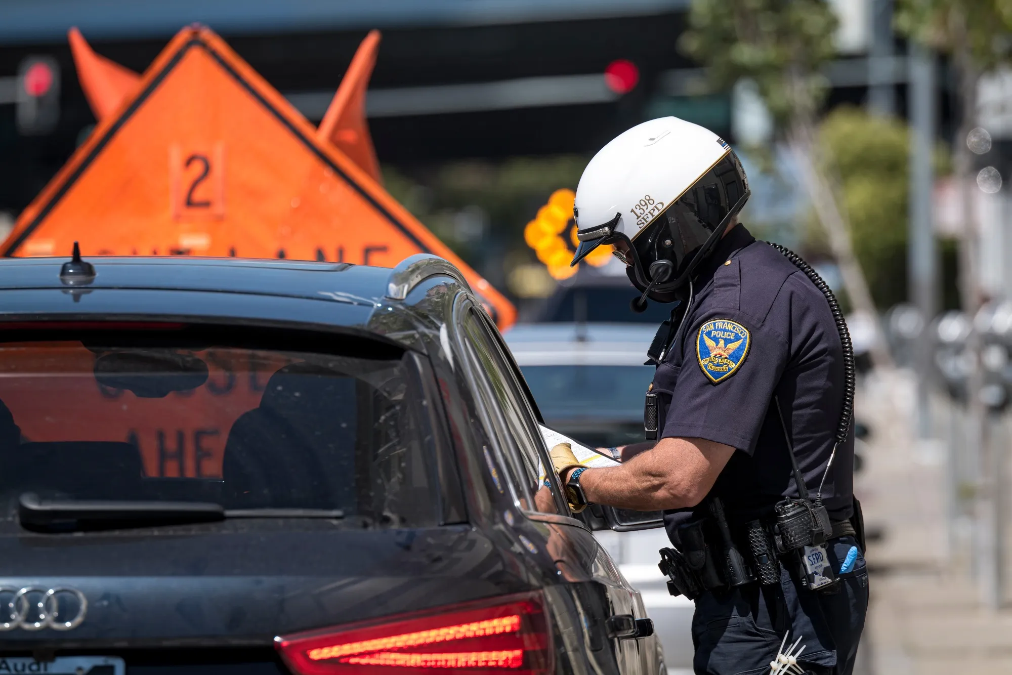 A City of San Francisco police officer issues a citation in San Francisco on June 16, 2020.&nbsp;