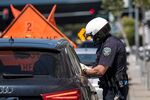 A City of San Francisco police officer issues a citation in San Francisco on June 16, 2020. 