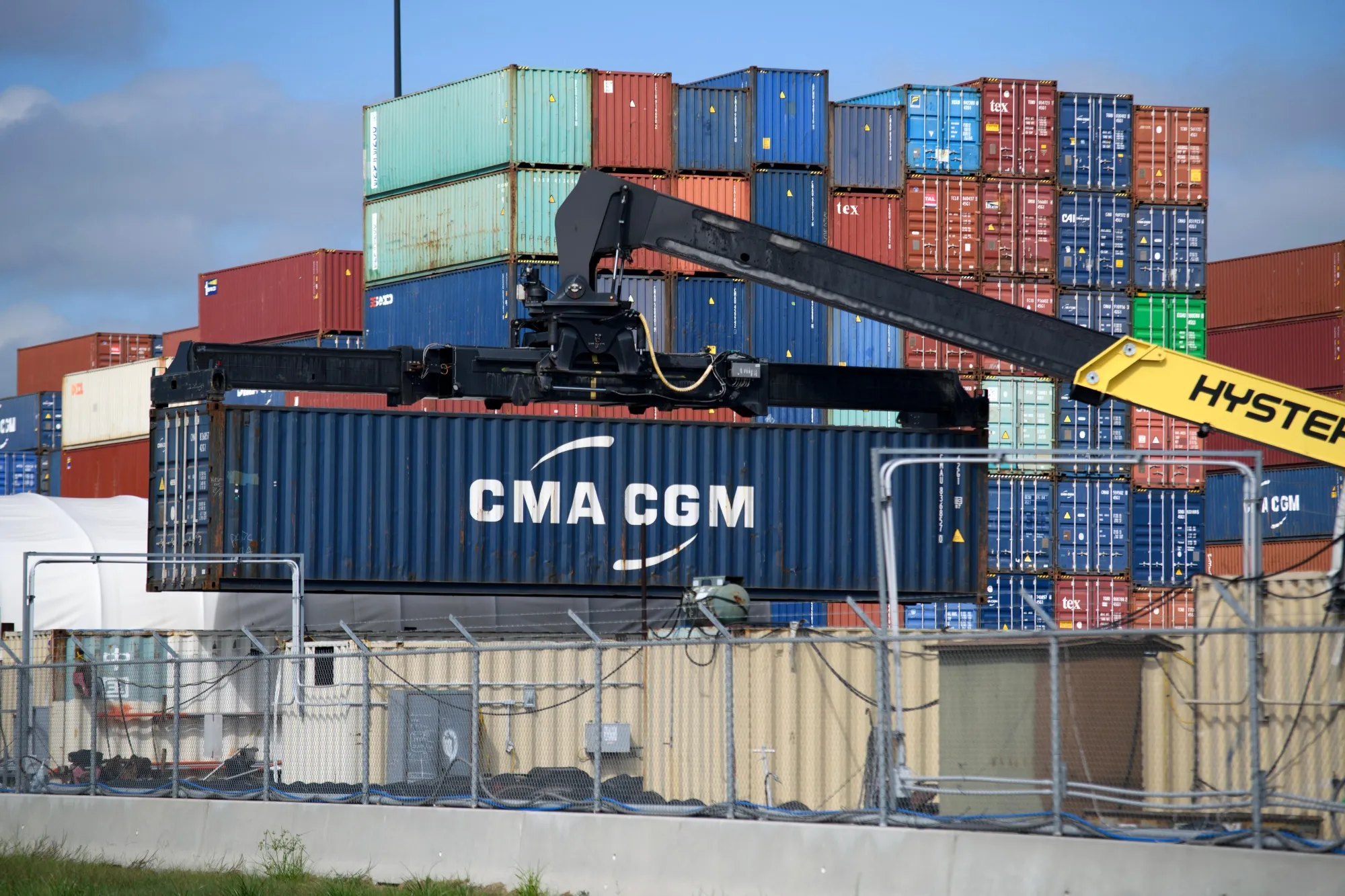 Workers move a shipping container at the Bayport Container Terminal in Houston.&nbsp;