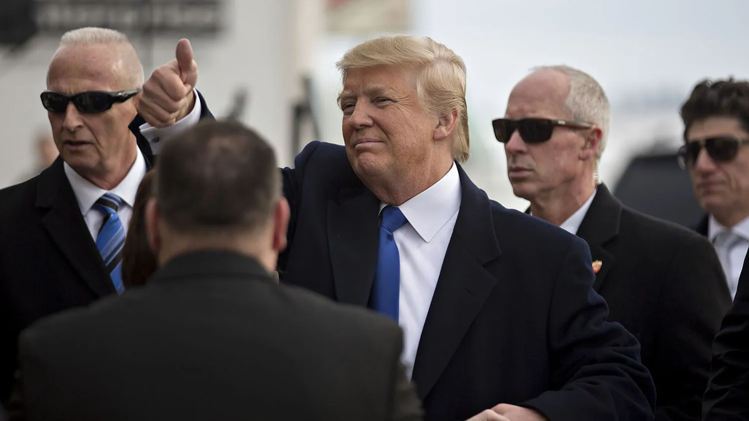 Donald Trump gestures to attendees after speaking during a campaign rally at Dubuque Regional Airport in Dubuque, Iowa, on Jan. 30, 2016.
