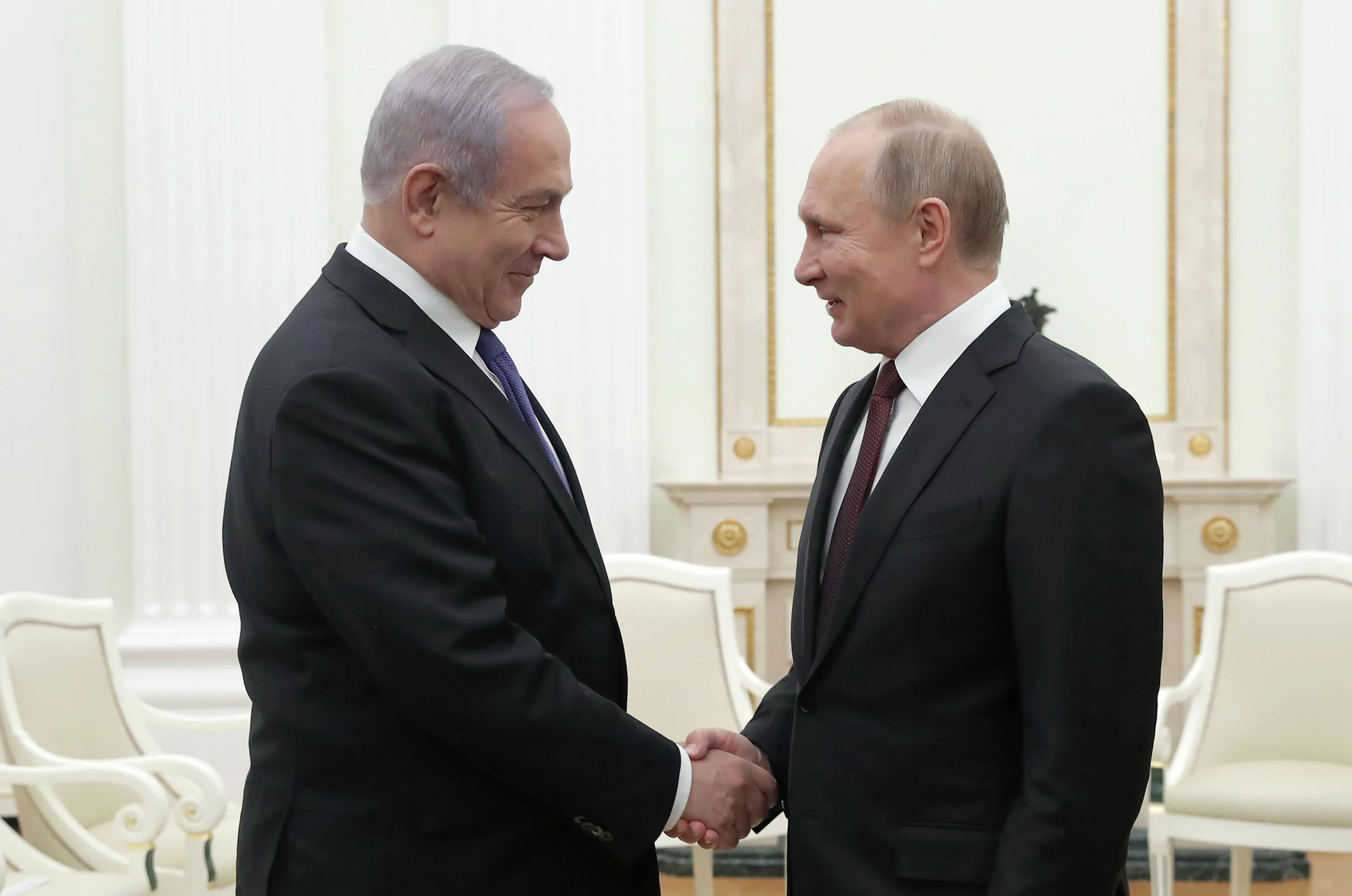 Russian President Vladimir Putin (R) shakes hands with Israeli Prime Minister Benjamin Netanyahu during a meeting at the Kremlin in Moscow on February 27, 2019. (Photo by MAXIM SHEMETOV / POOL / AFP)        (Photo credit should read MAXIM SHEMETOV/AFP/Getty Images)