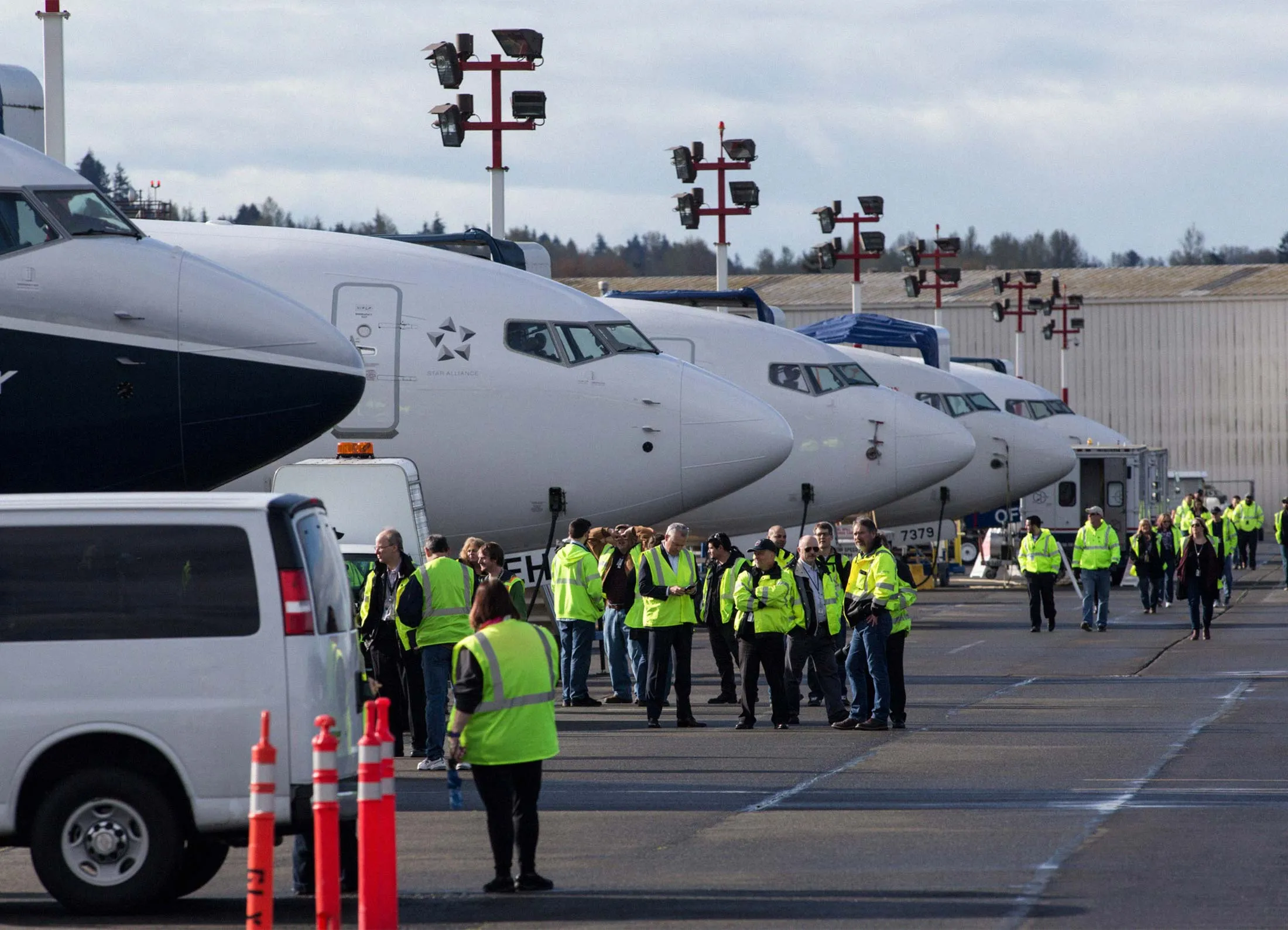 Boeing employees wait near the 737 Max 9, left, in a row of other 737s, before the Max 9’s first test flight in Renton, Wash., on April 13, 2017.
