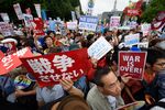 People protest against Shinzo Abe's security bills outside the National Diet building in Tokyo on Sunday.

