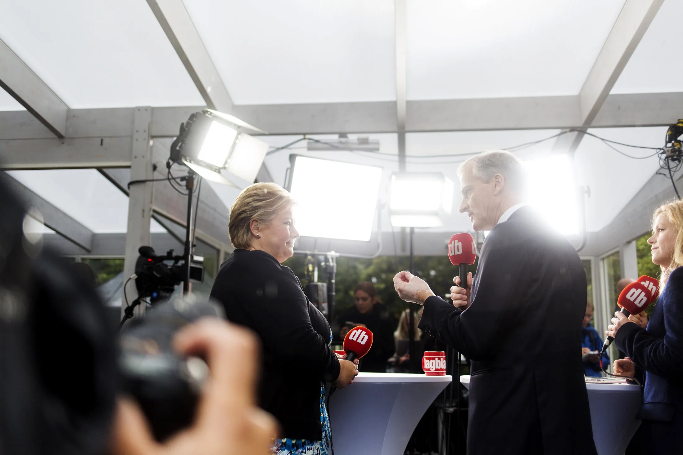 Erna Solberg, Norway's prime minister, left, listens as Jonas Gahr Store, leader of Norway's Labor Party, speaks during a televised political debate outside the parliament ahead of the election in Oslo, Norway, on Sept. 6.
