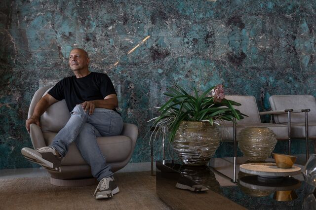 Carlos Trossini sitting in a chair at his penthouse at the Bravissima Residences.