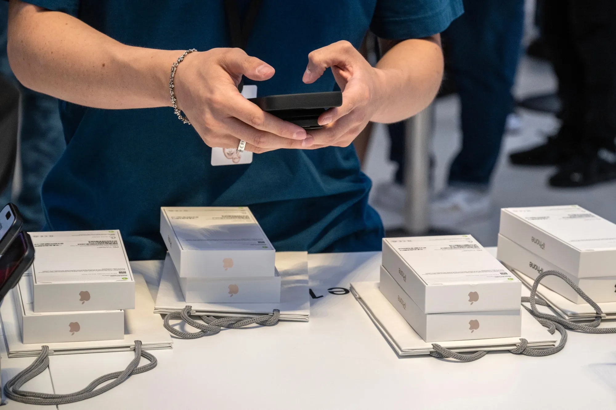 A worker sells Apple iPhones at Apple's store in New York.