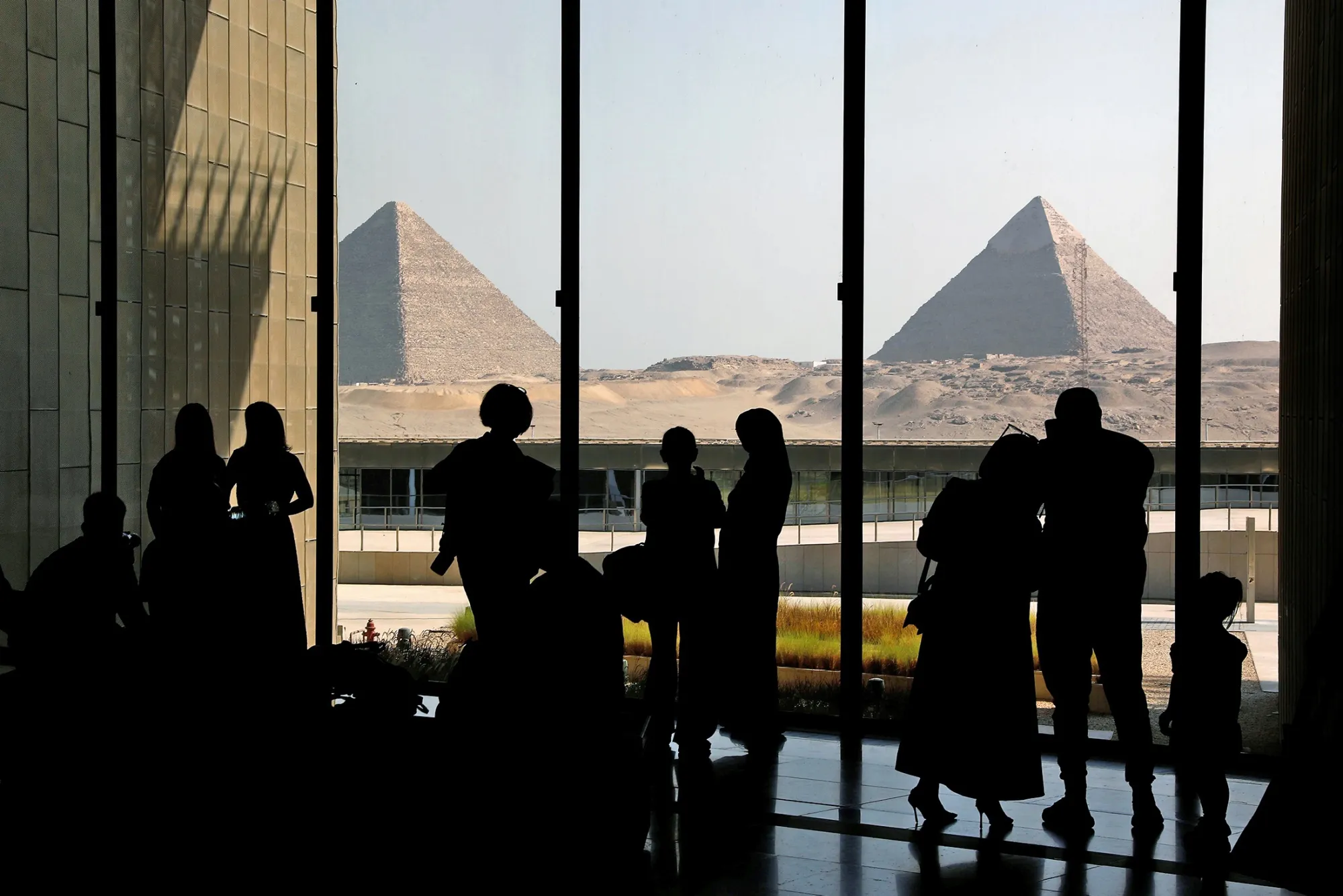 Tourists view the Giza Pyramids while visiting the Grand Egyptian Museum in Giza, Egypt in October.
