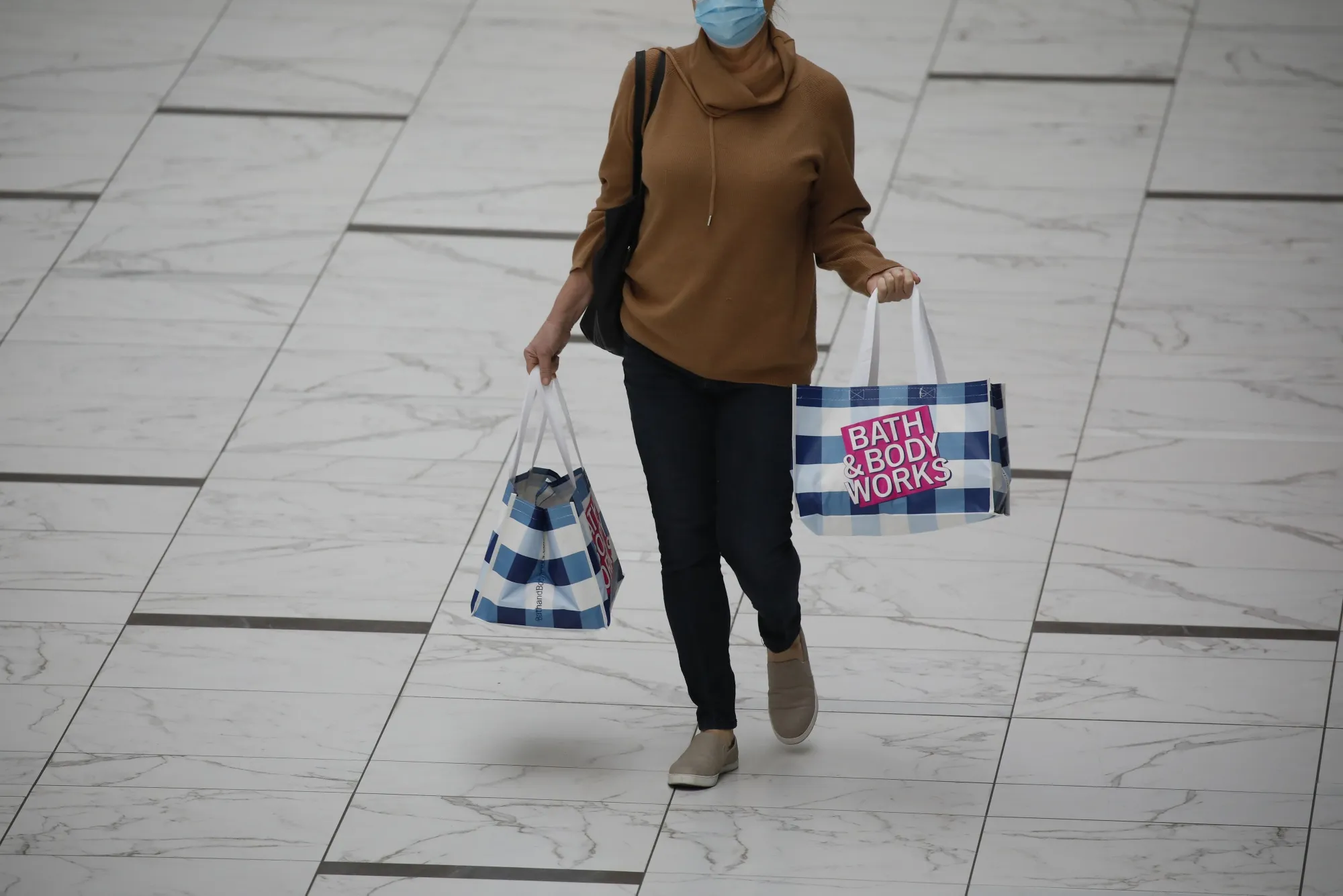 A shopper carries Bath &amp; Body Works bags in Columbus, Ohio.