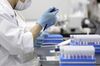 A technician handles a DNA sample at a Genesis Healthcare Co. laboratory in Tokyo, Japan, on Wednesday, July 4, 2018. DNA testing at home in Japan is starting to gain traction as more people age and seek answers about their risks for diseases.